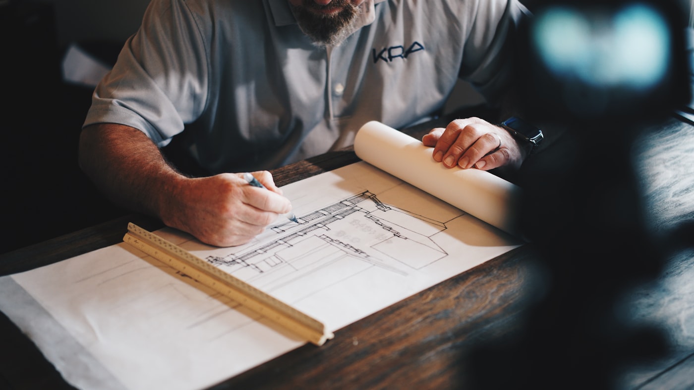 Architectural drawings and drafting tools laid out on a desk